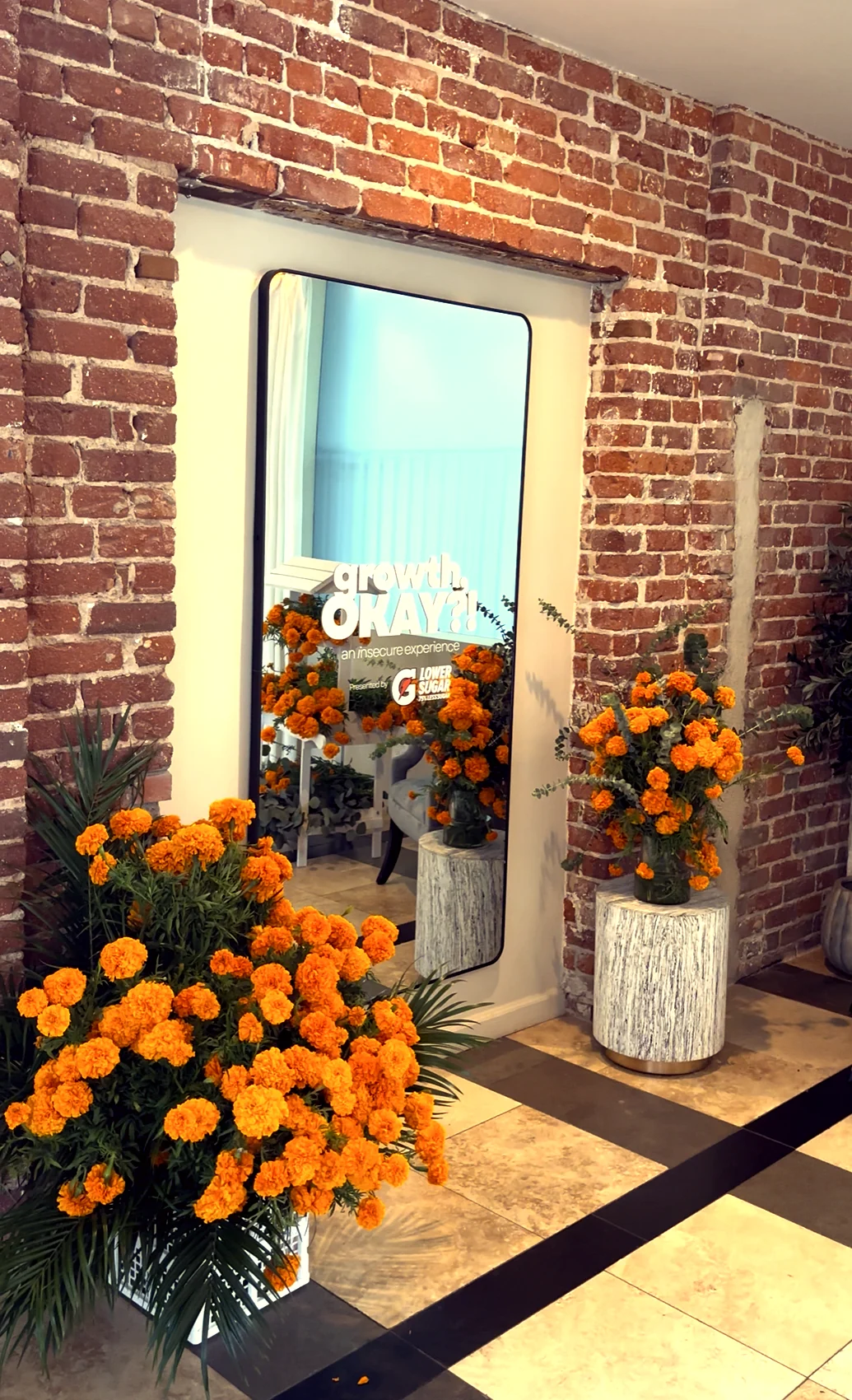 Marigold installation framing a mirror at a brand activation